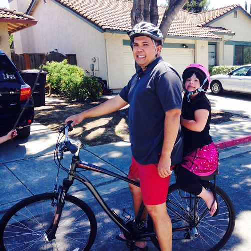 Father and daughter riding on Companion Bike Seat for the first time