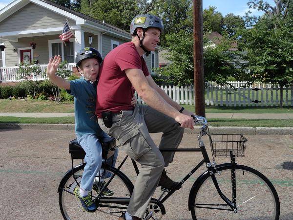 father and son riding with Companion Bike Seat
